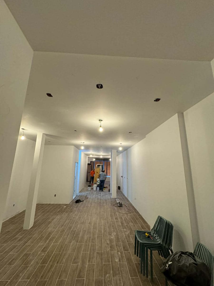 Renovated interior room with new walls and wood flooring