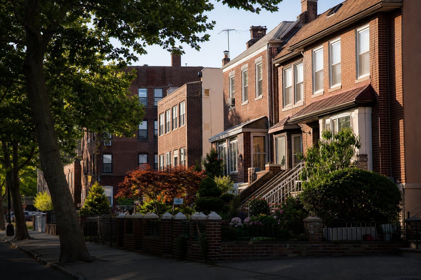 Representative Queens residential block with brick homes and front gardens