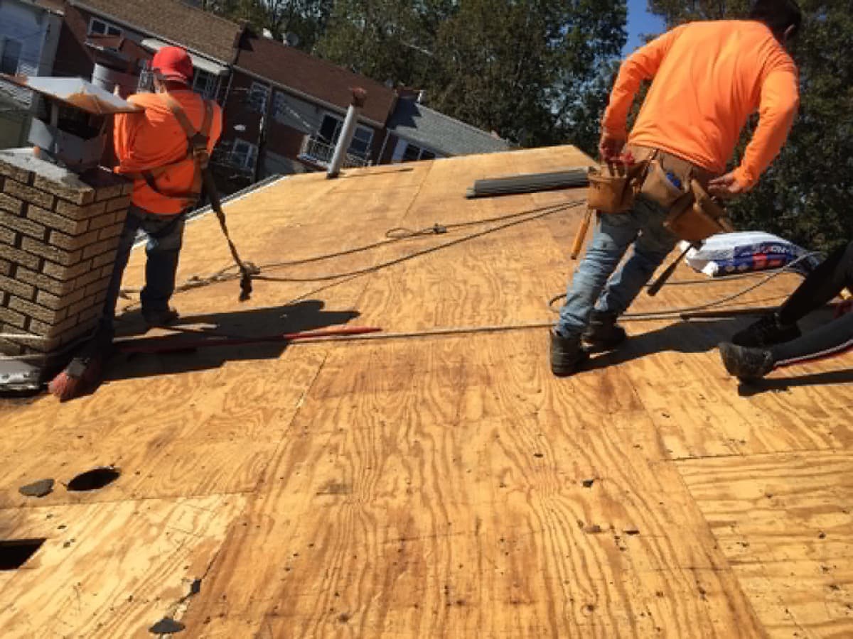 Roofing crew working on roof decking