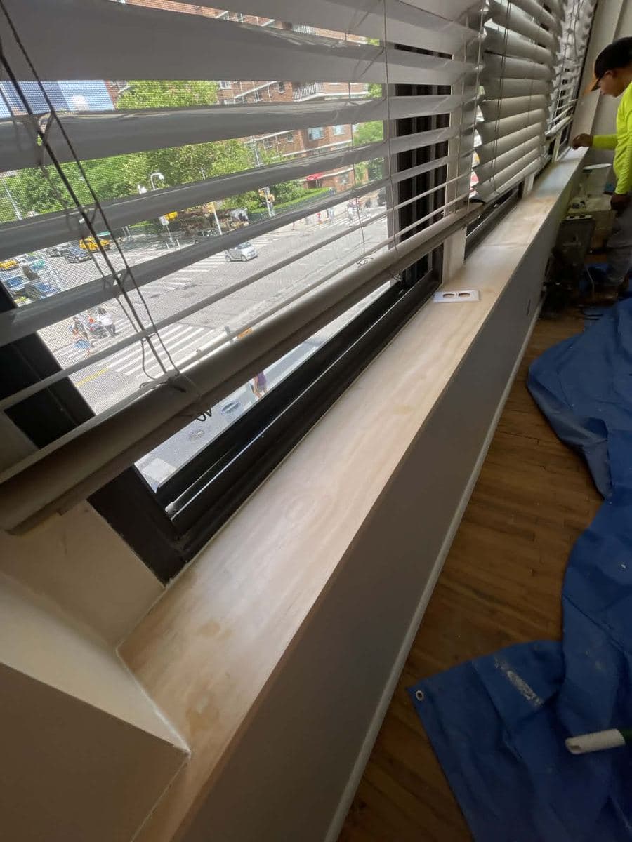 Finished interior window area with new sill and wood flooring