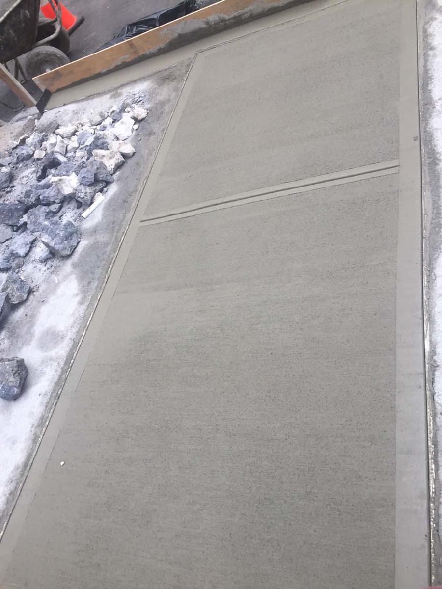 Fresh concrete panel with finished edges and control joint details