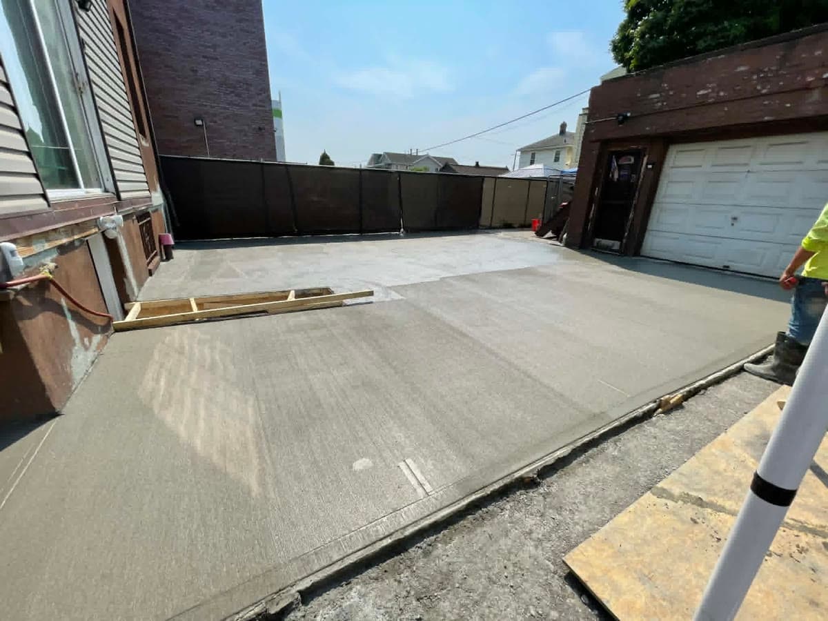 Broad newly placed concrete slab with a broom-finished surface