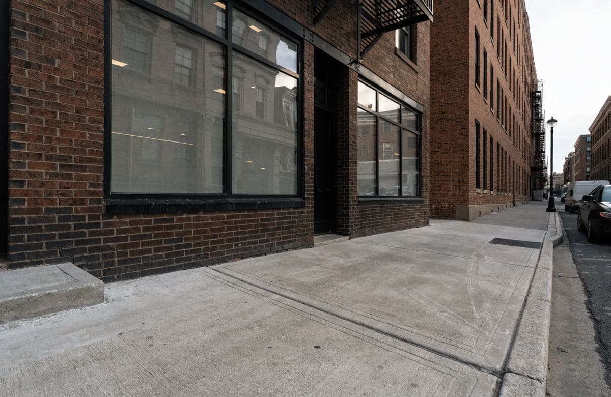 Illustrative commercial storefront with a new concrete entry sidewalk