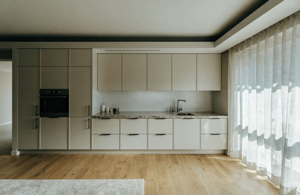 Illustrative finished modern apartment kitchen with new cabinets