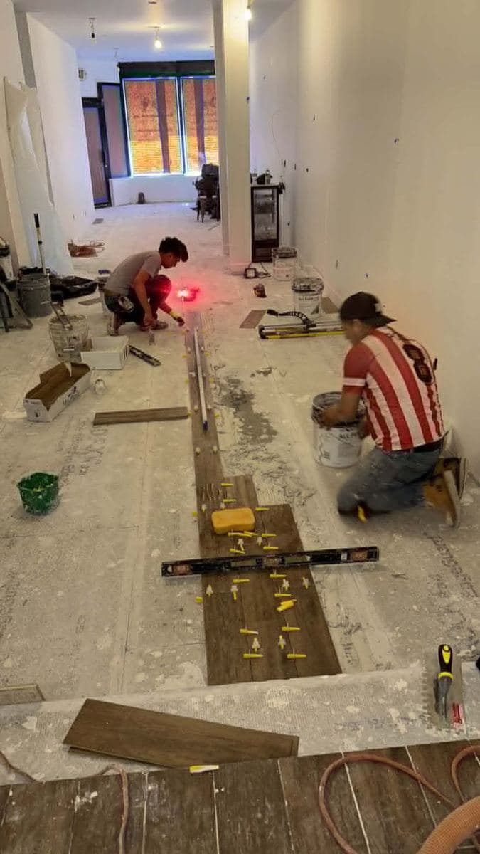 Crew installing new wood flooring during a remodeling project