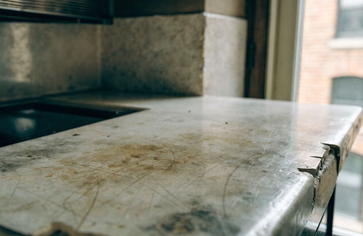 Illustrative worn, damaged kitchen countertop