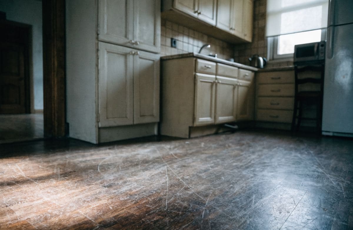 Illustrative worn, scratched kitchen flooring