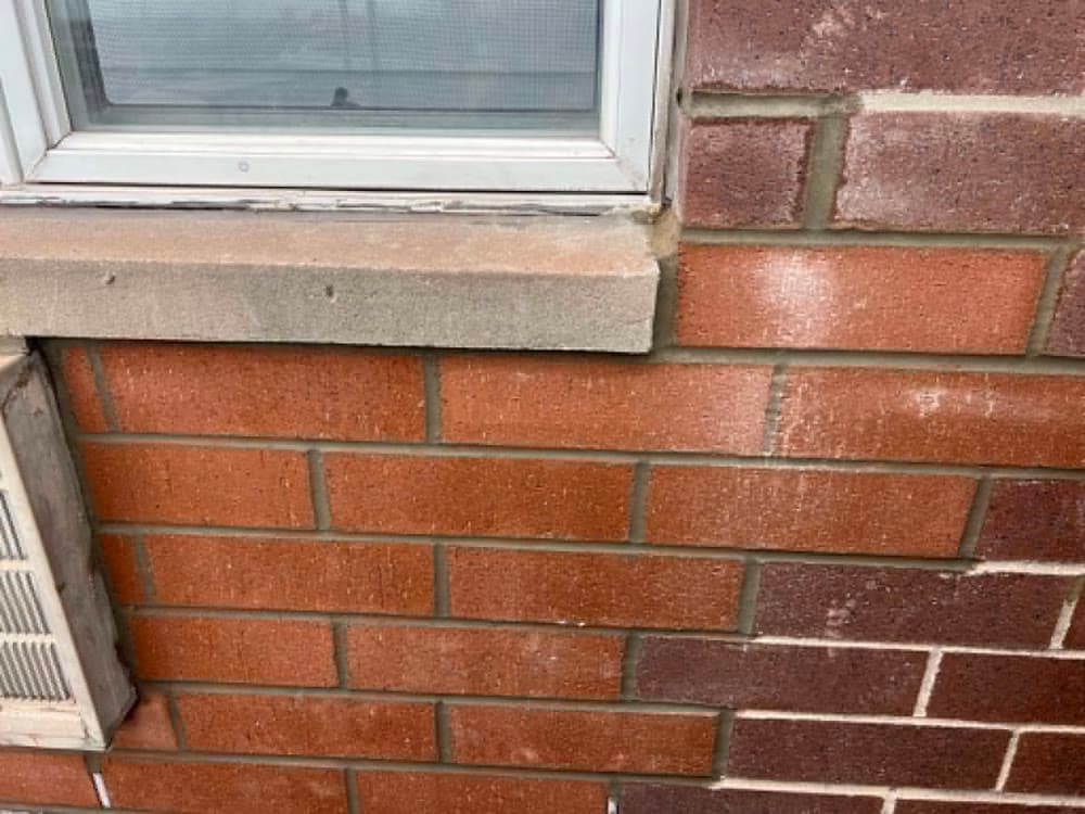 Close view of brick facade courses and finished mortar joints