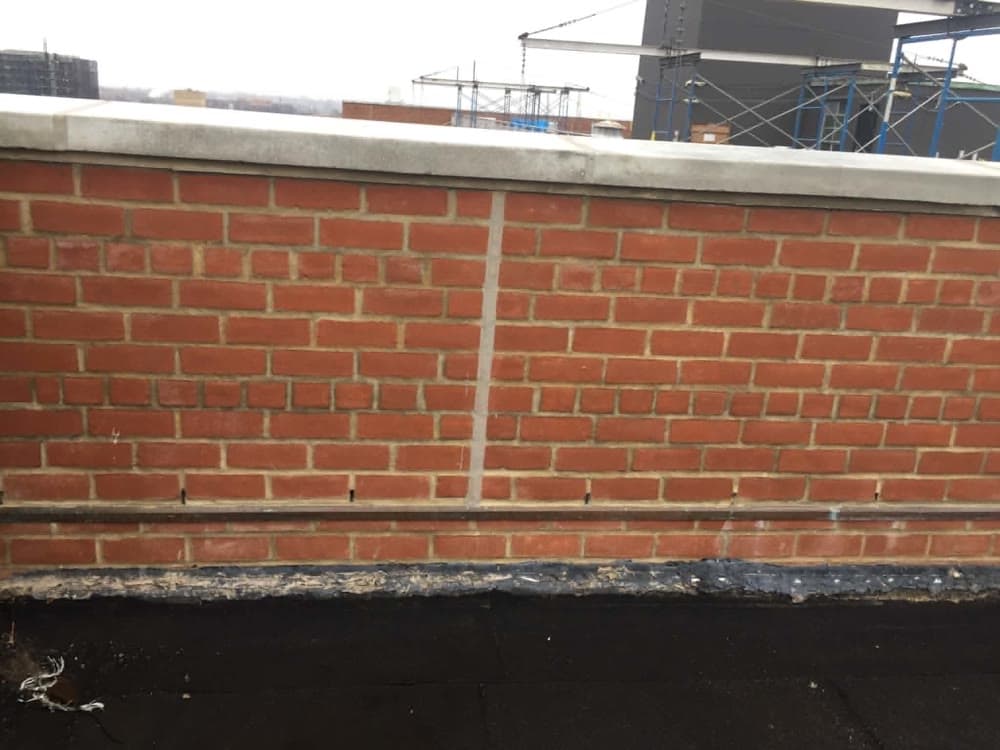 Close inspection of brick joints and exterior masonry condition