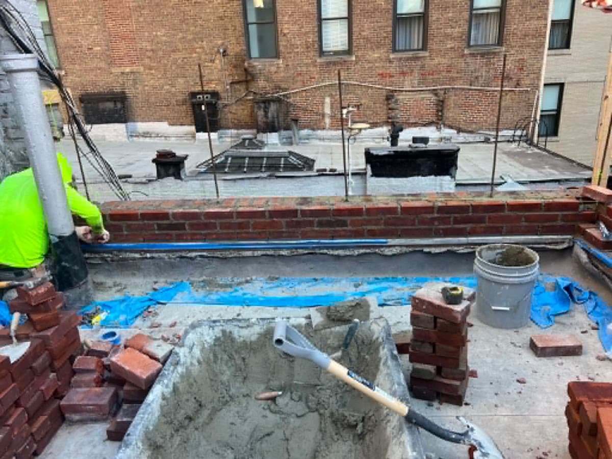 Newly built brick wall with aligned courses and finished mortar joints