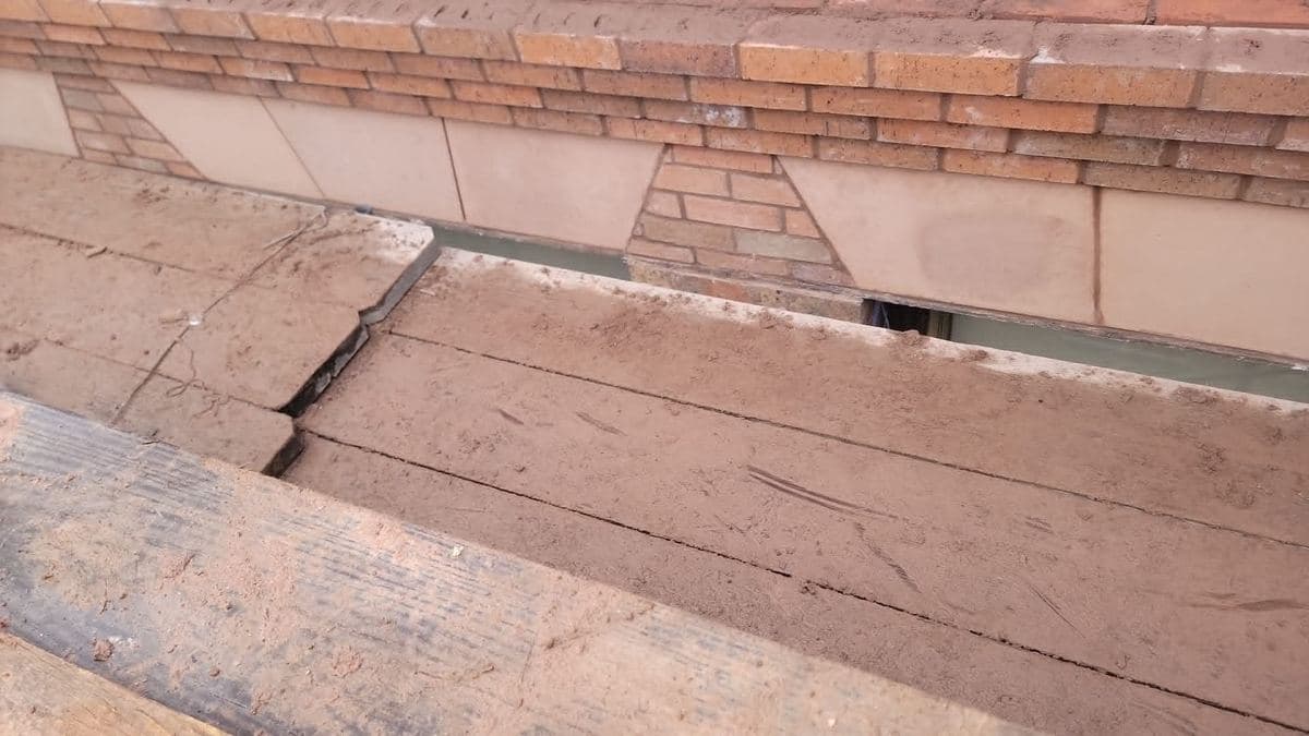 Brick parapet edge with coping along a rooftop
