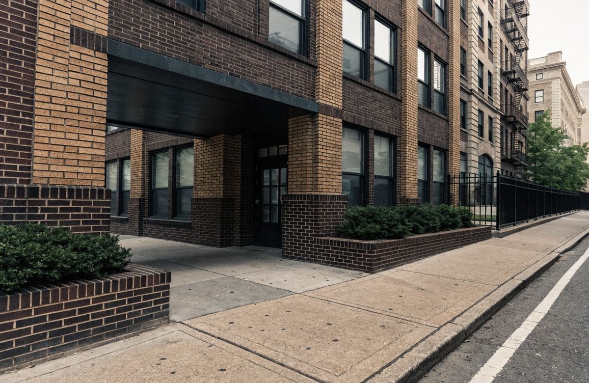 Illustrative brick condominium entrance with masonry columns