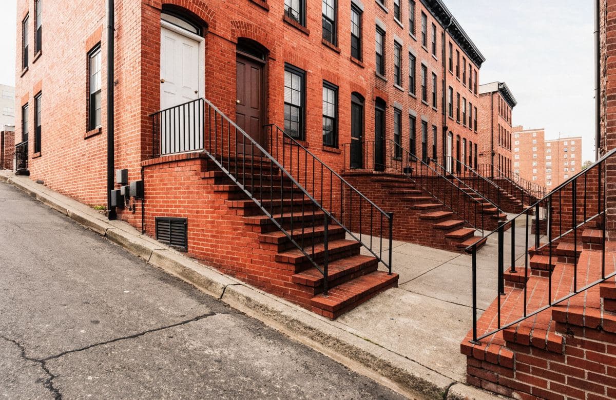 Illustrative red brick multifamily rowhouses with masonry stoops