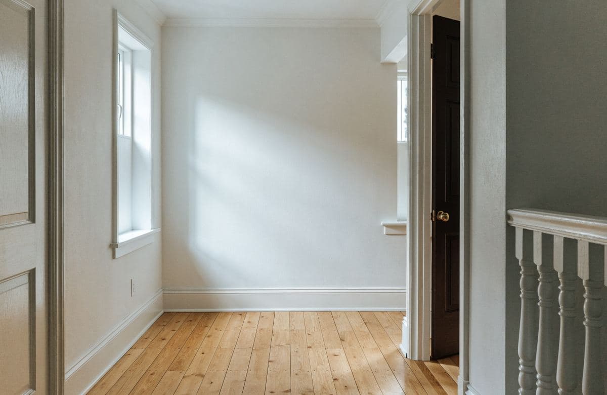 Illustrative freshly painted single-family home room with wood flooring