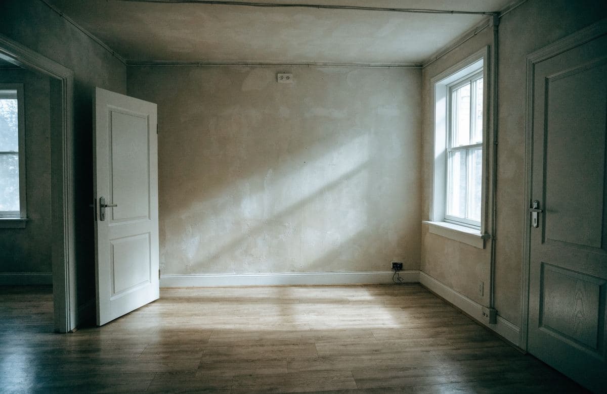 Illustrative empty rental room with plain walls ready for a fresh coat