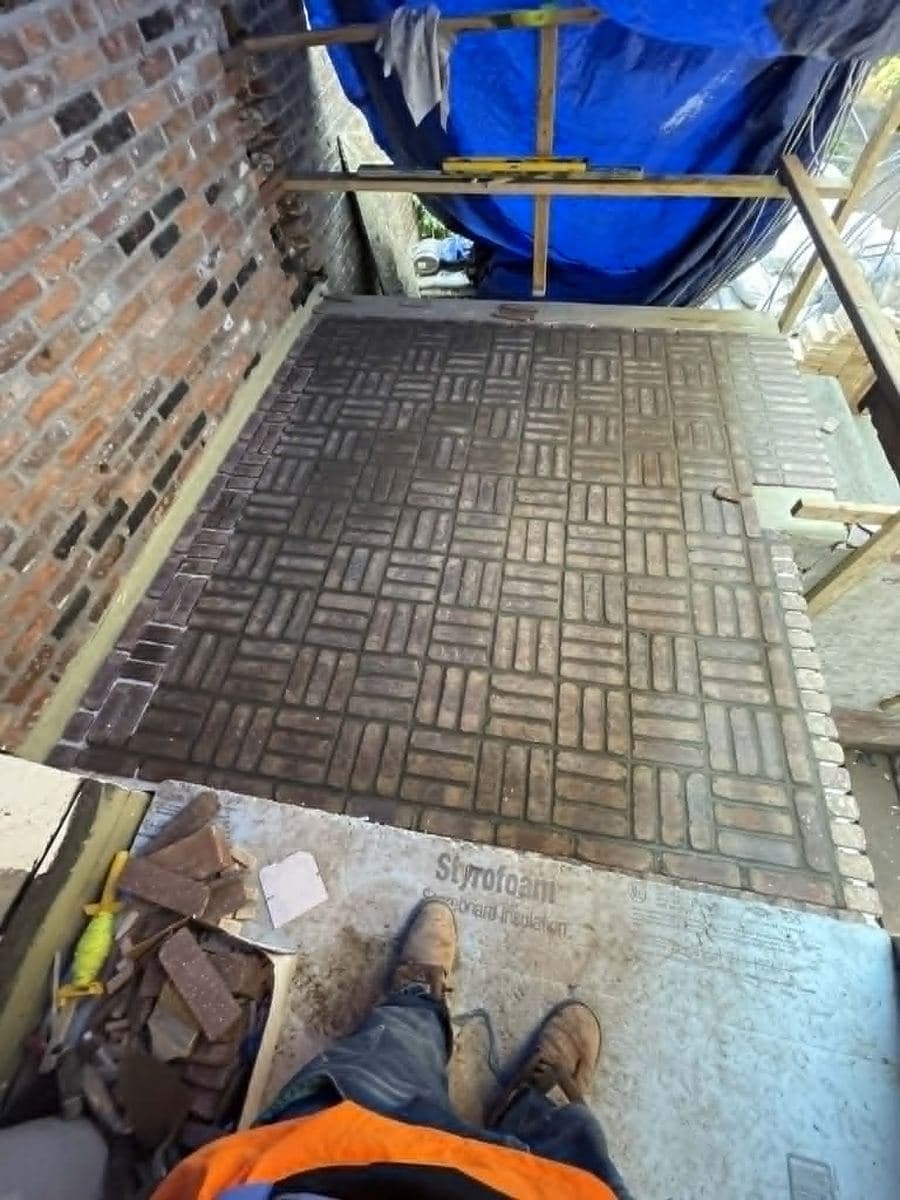 Herringbone-pattern paver surface during installation work