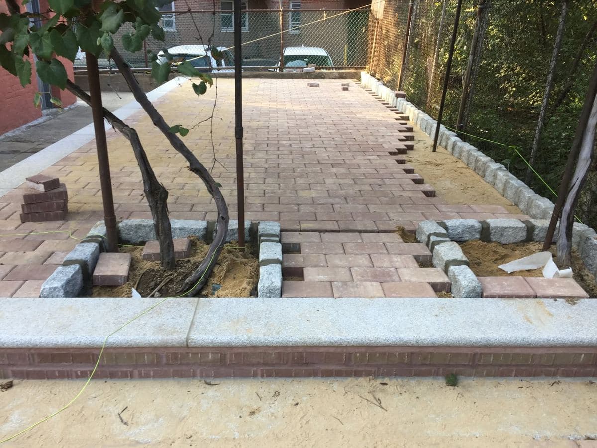Paver field being extended with border blocks staged in place
