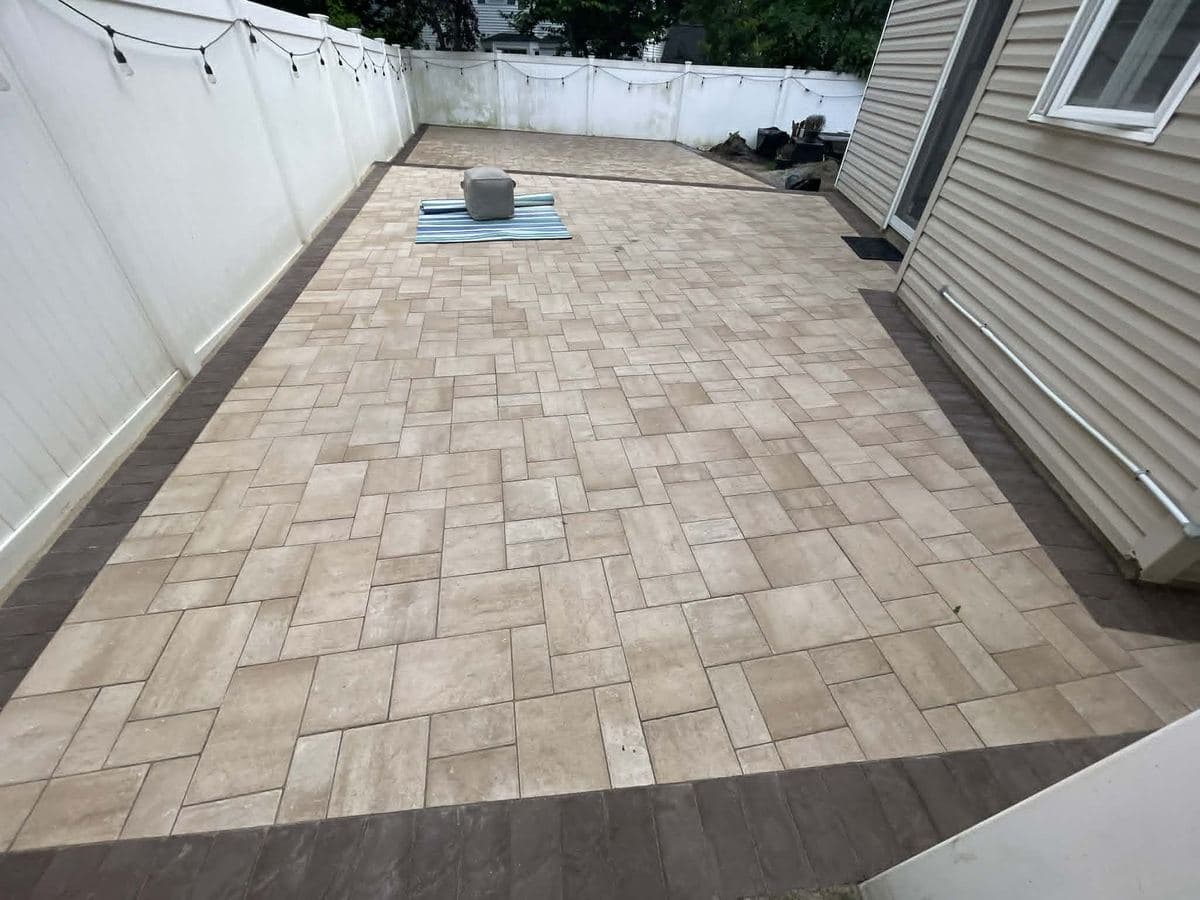 Paver patio surface installed across a residential outdoor area