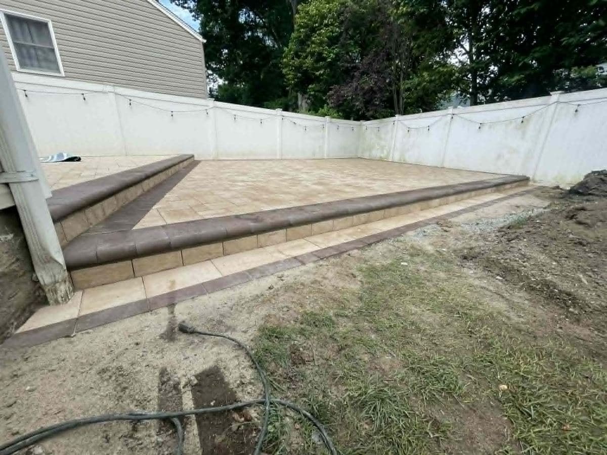 Finished paver yard with a raised border along the planted edge