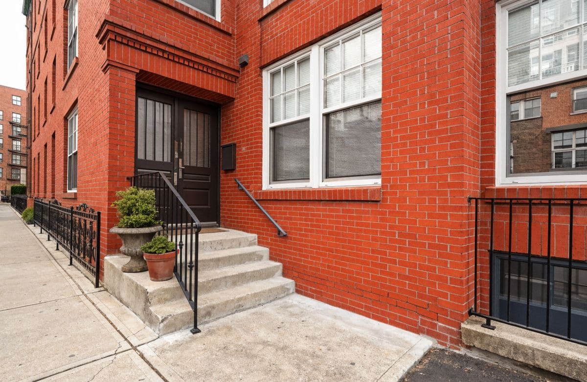 Illustrative brick condominium entrance with clean repointed walls
