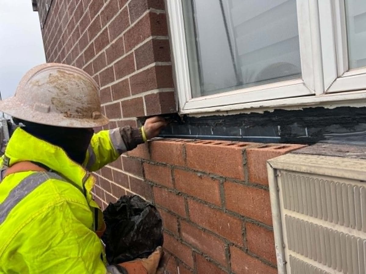 Fresh repointing work across a red brick wall