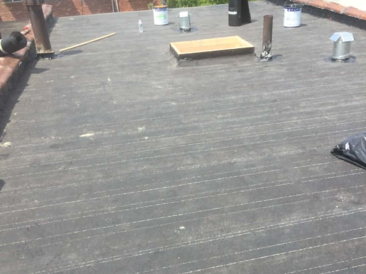 Completed flat roofing surface with vents and roof penetrations