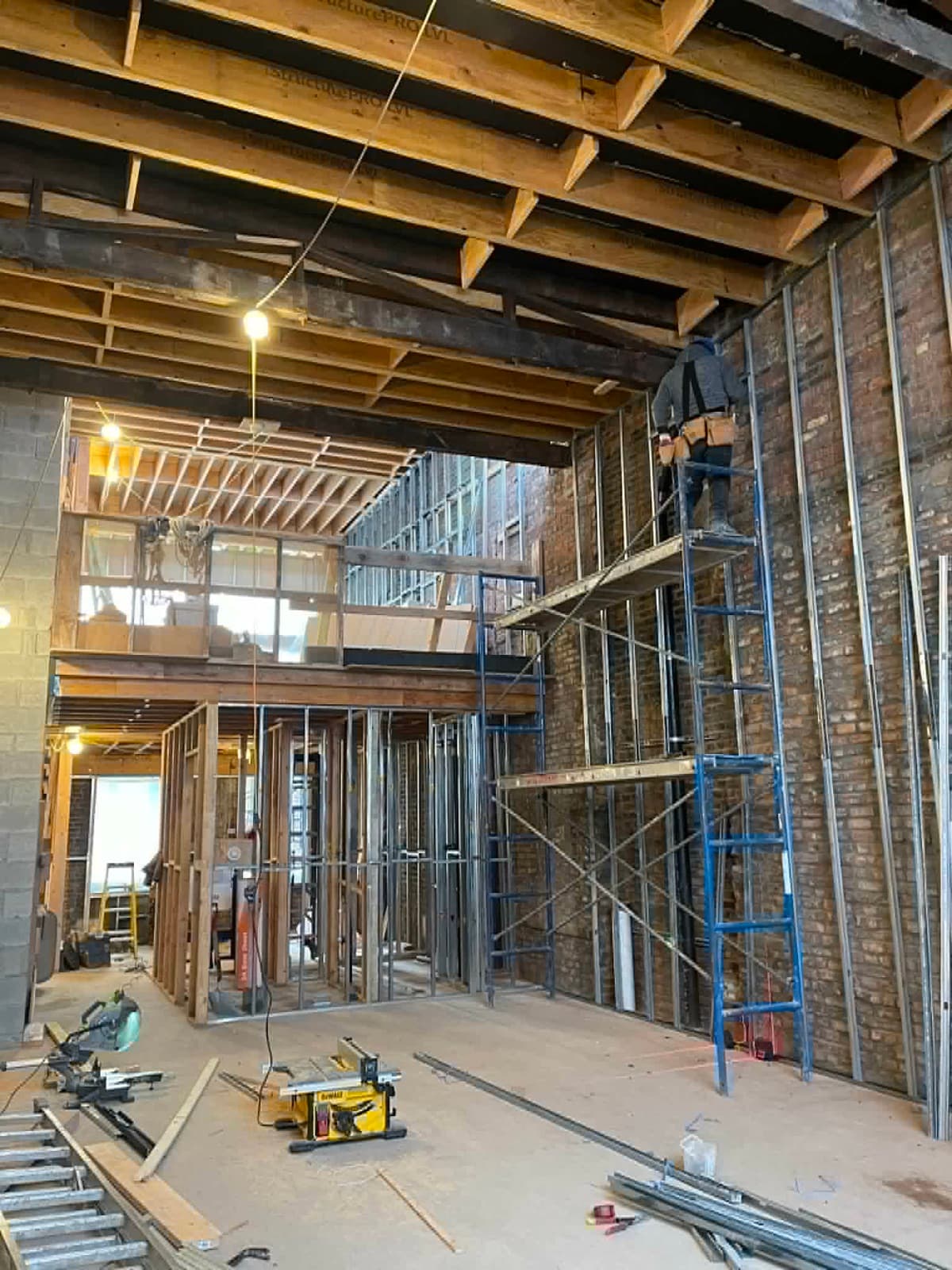 Large interior construction project with framing and scaffolding in progress